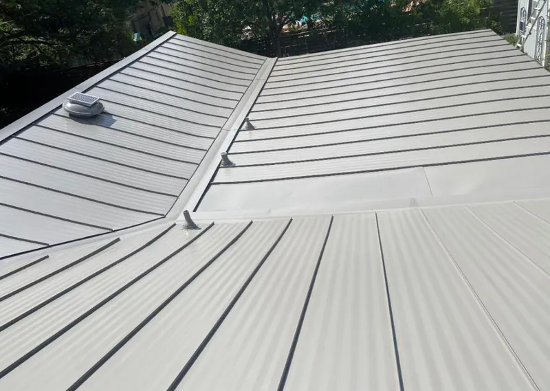 Solar attic fan installed on a metal roof for Roof Ventilation in Benton Harbor
