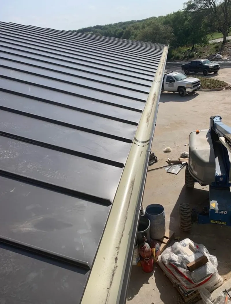 Standing seam panel and gutter detail on a metal roofing jobsite in Benton Harbor